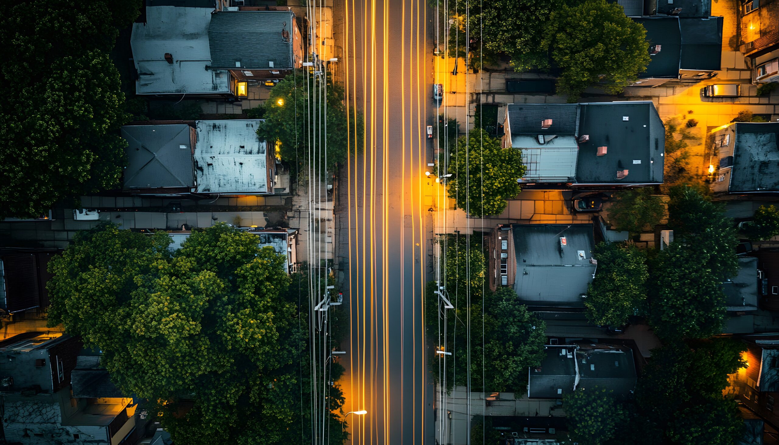 Urban street scene at dusk, viewed from above.
