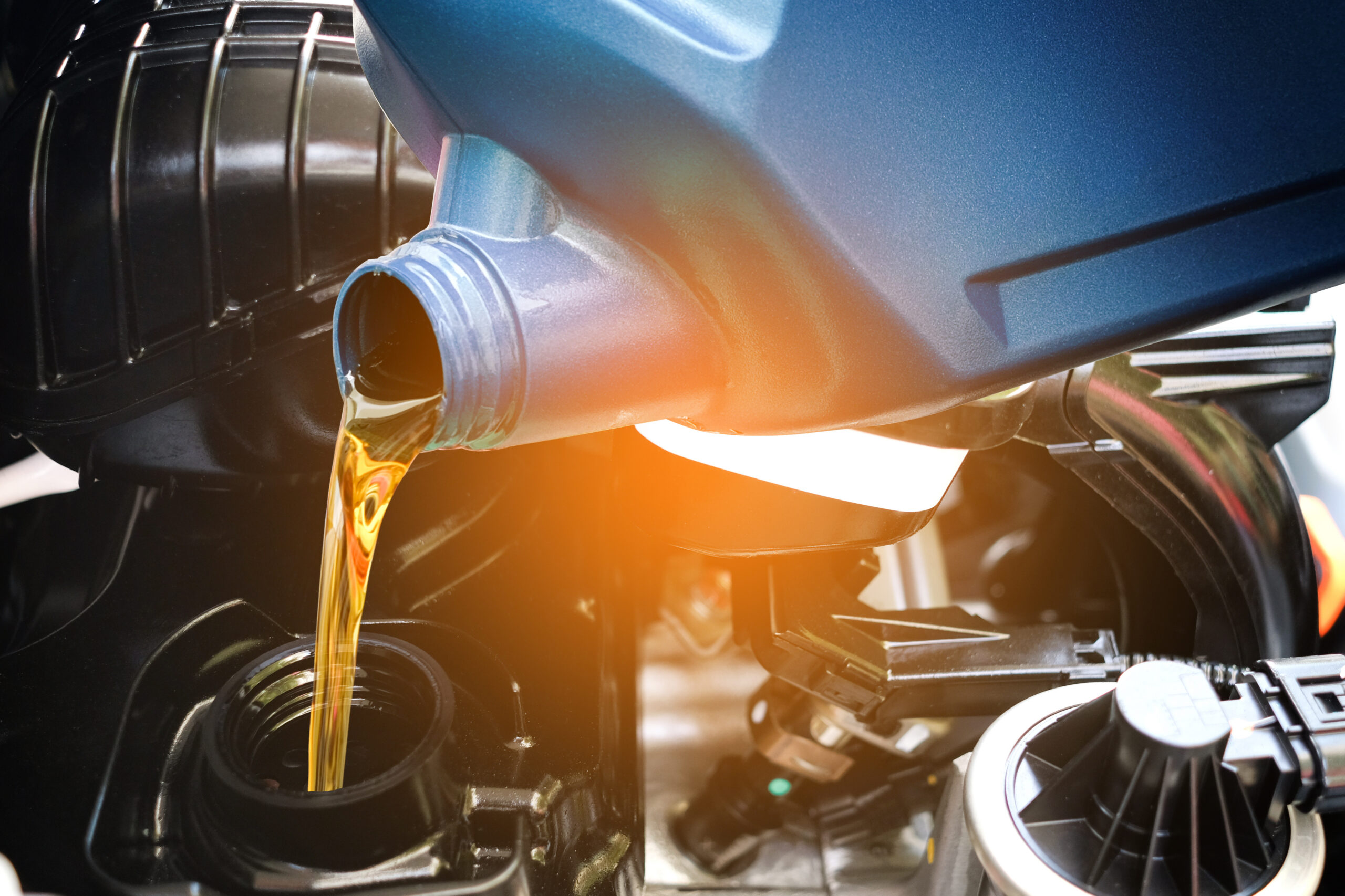 Refueling and pouring oil quality into the engine motor car Transmission and Maintenance Gear .Energy fuel concept.